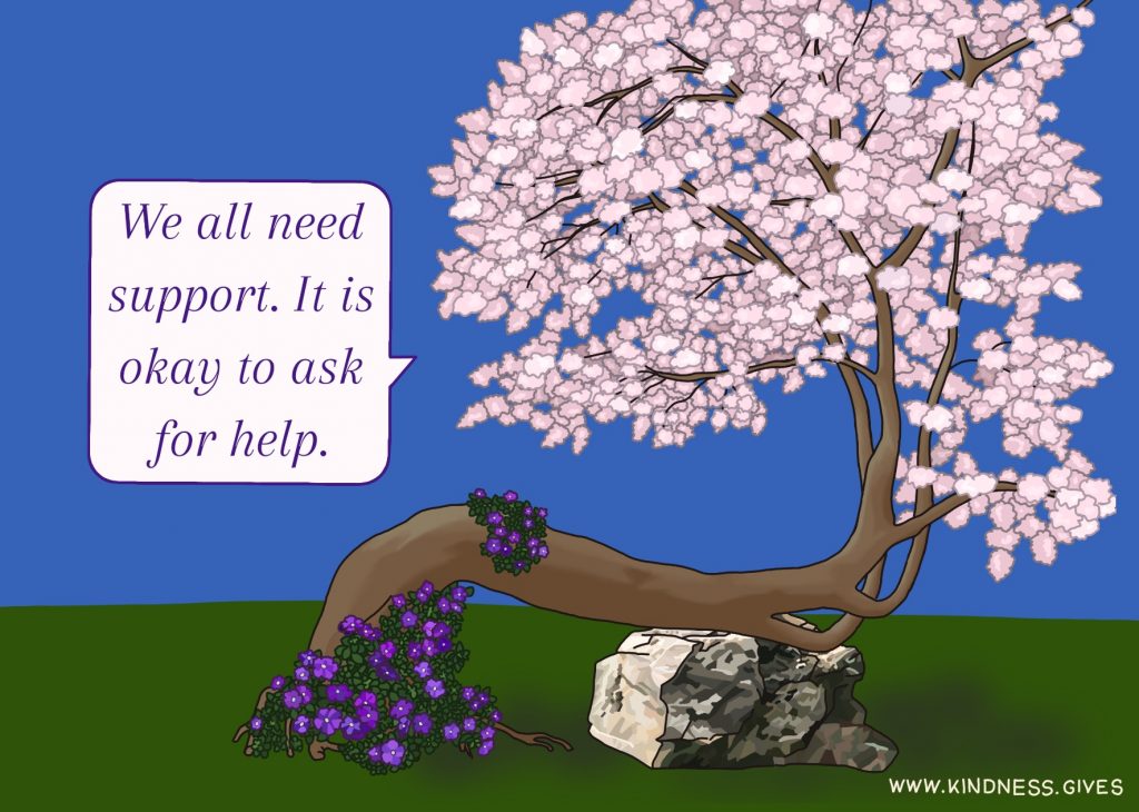 A crooked cherry tree in bloom propped up by a rock says "We all need support. It is okay to ask for help."